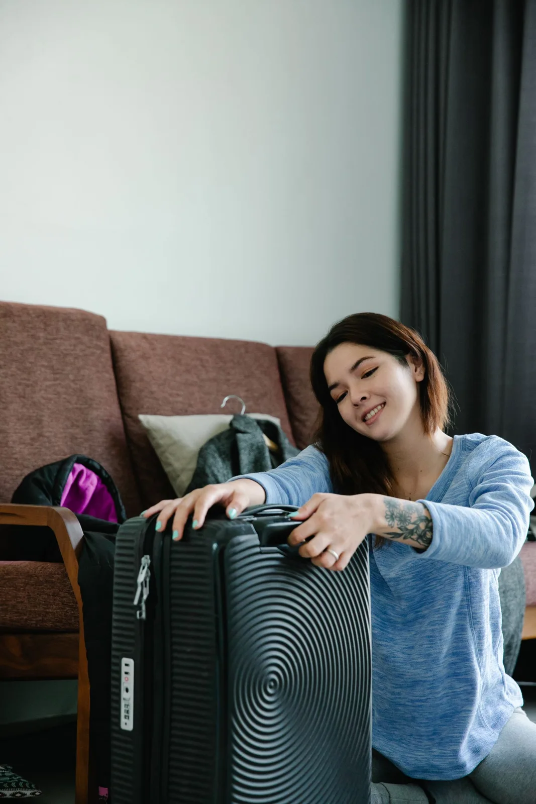 Woman with a suitcase in a living room
