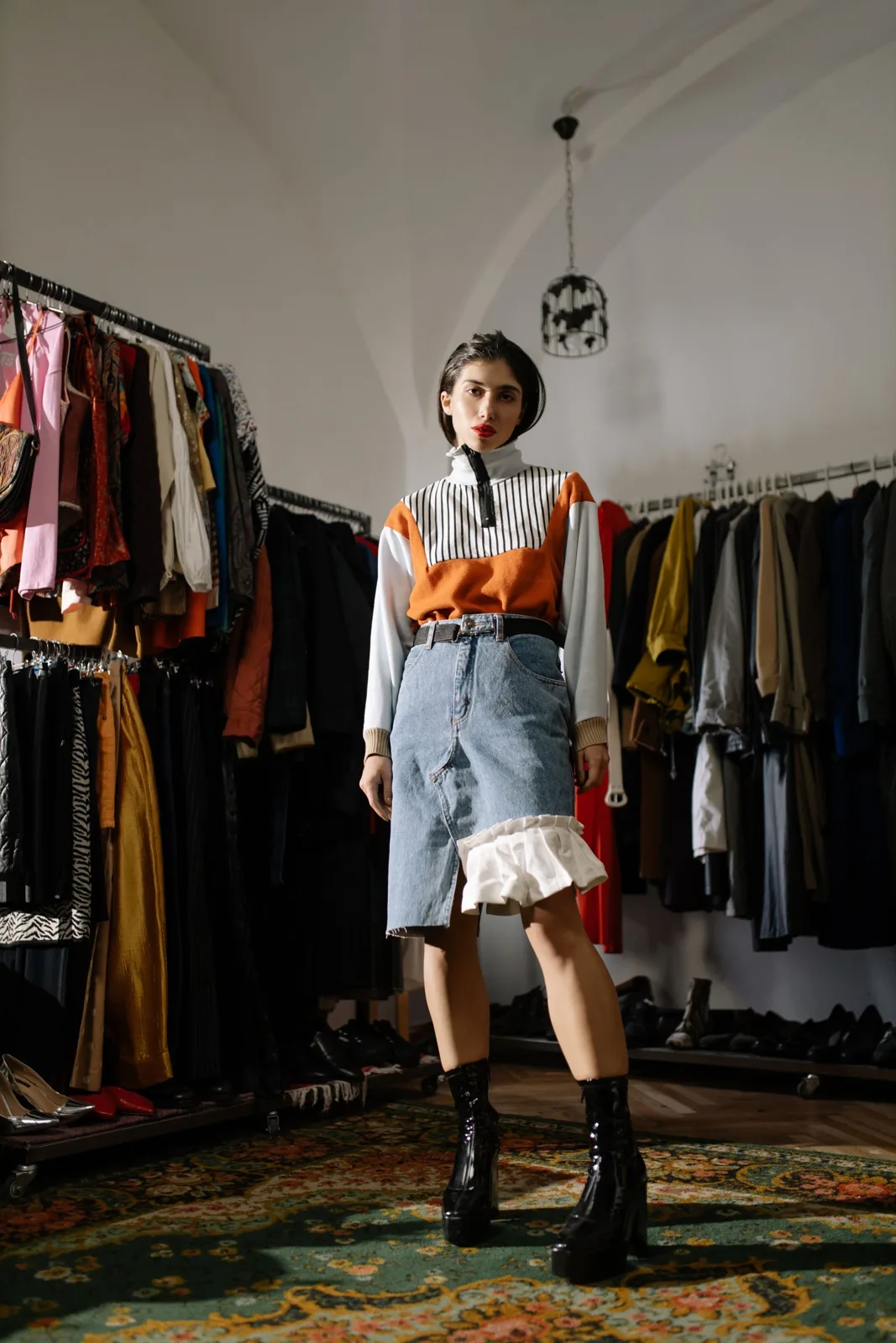 Woman standing beside a clothing rack