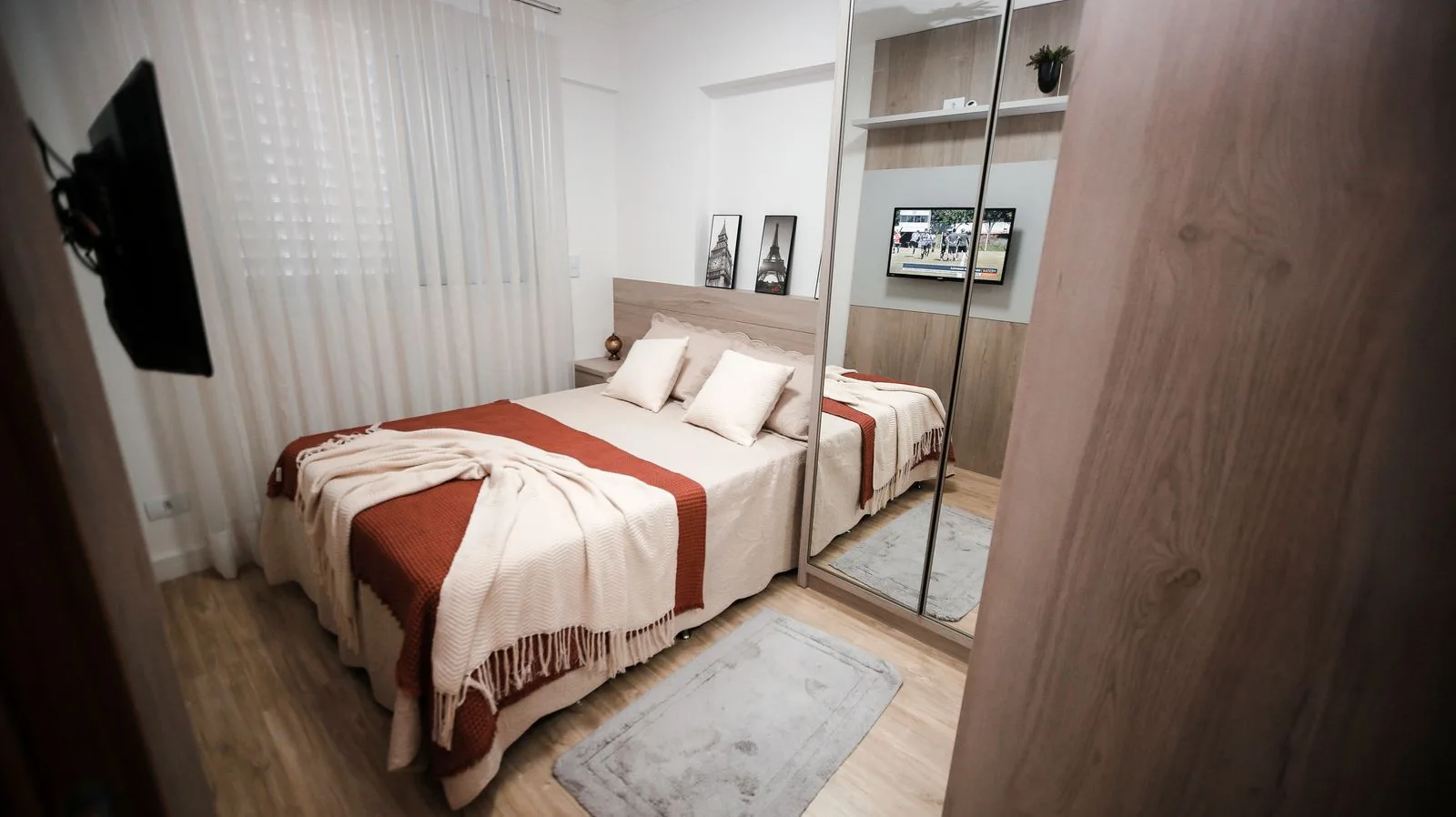 Neutral bedroom with layered bed linen