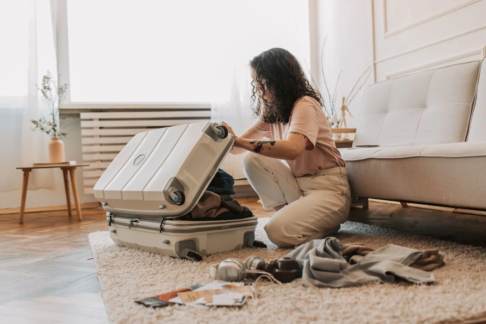 Woman packing luggage at home